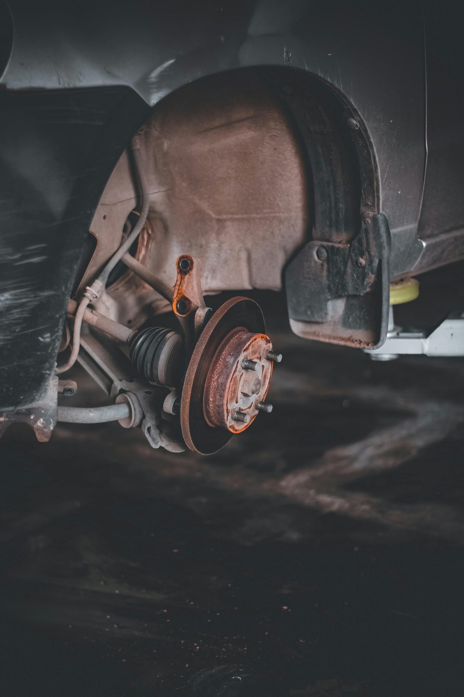 pexels-photo-8651900-8651900 Close-up of a rusty car brake system highlighting repair needs and maintenance.