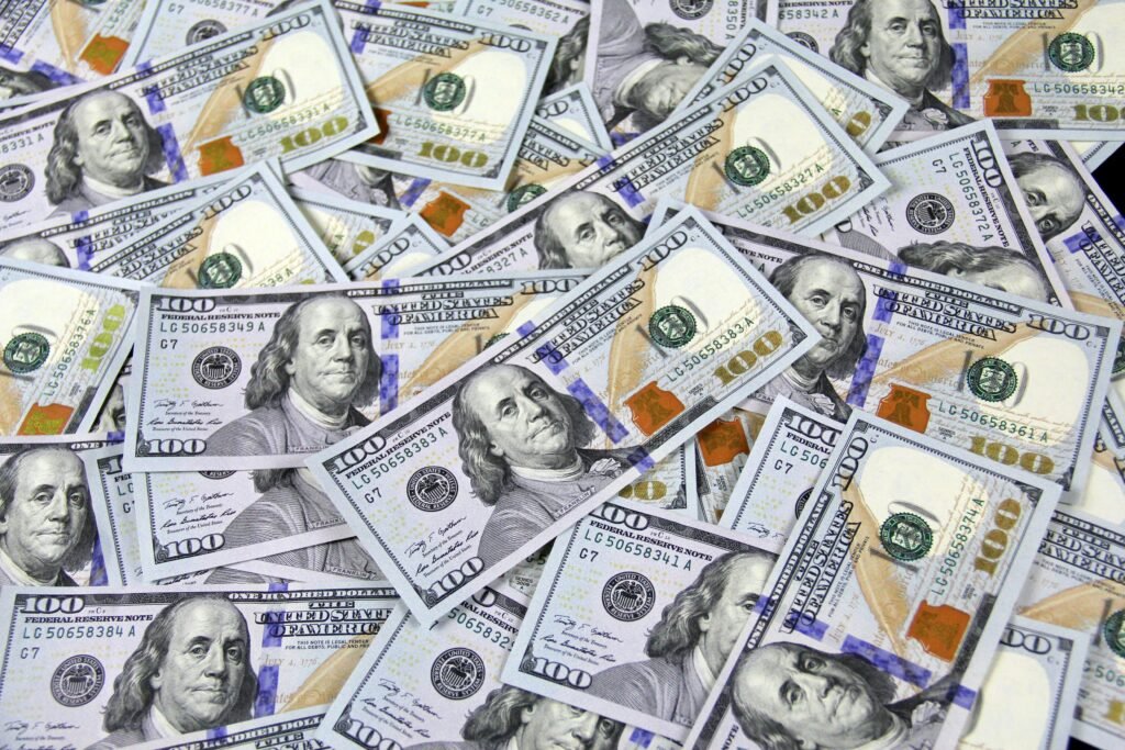 pexels-photo-3483098-3483098 Pile of US hundred dollar bills depicting financial success and wealth.